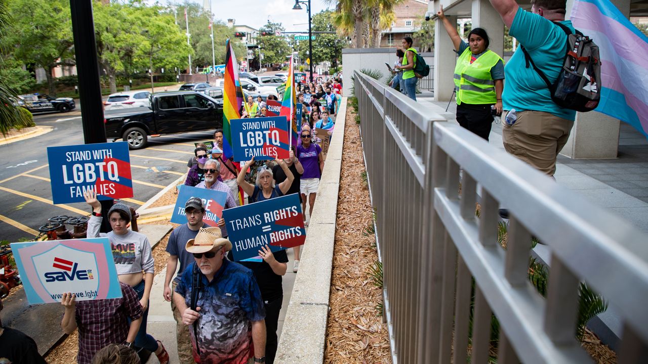 People march in Tallahassee, Florida, on March 31, 2023, to protest legislation that would expand the prohibition on certain classroom instruction about sexual orientation and gender identity. 
