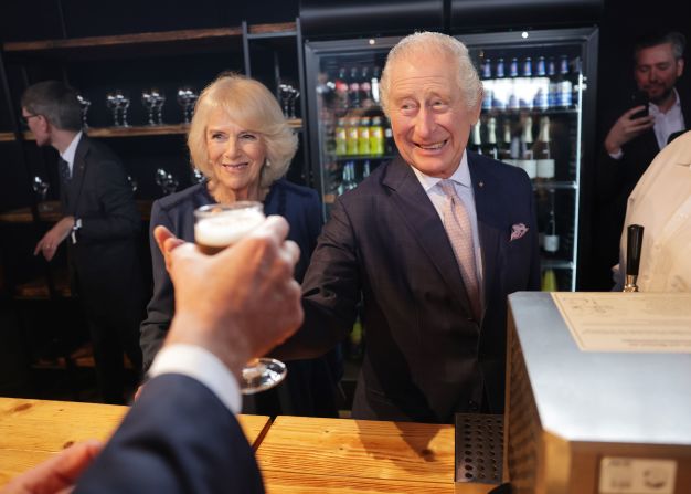 The King and Queen Consort make a toast at their final reception in Hamburg.