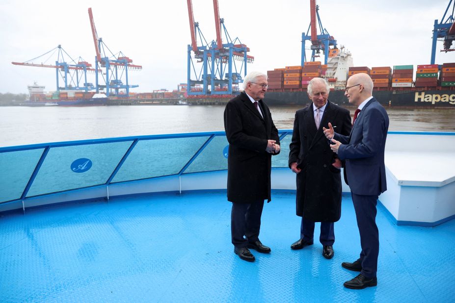 German President Frank-Walter Steinmeier, left, and the King speak with Hamburg Mayor Peter Tschentscher as they tour Hamburg's harbor on Friday.