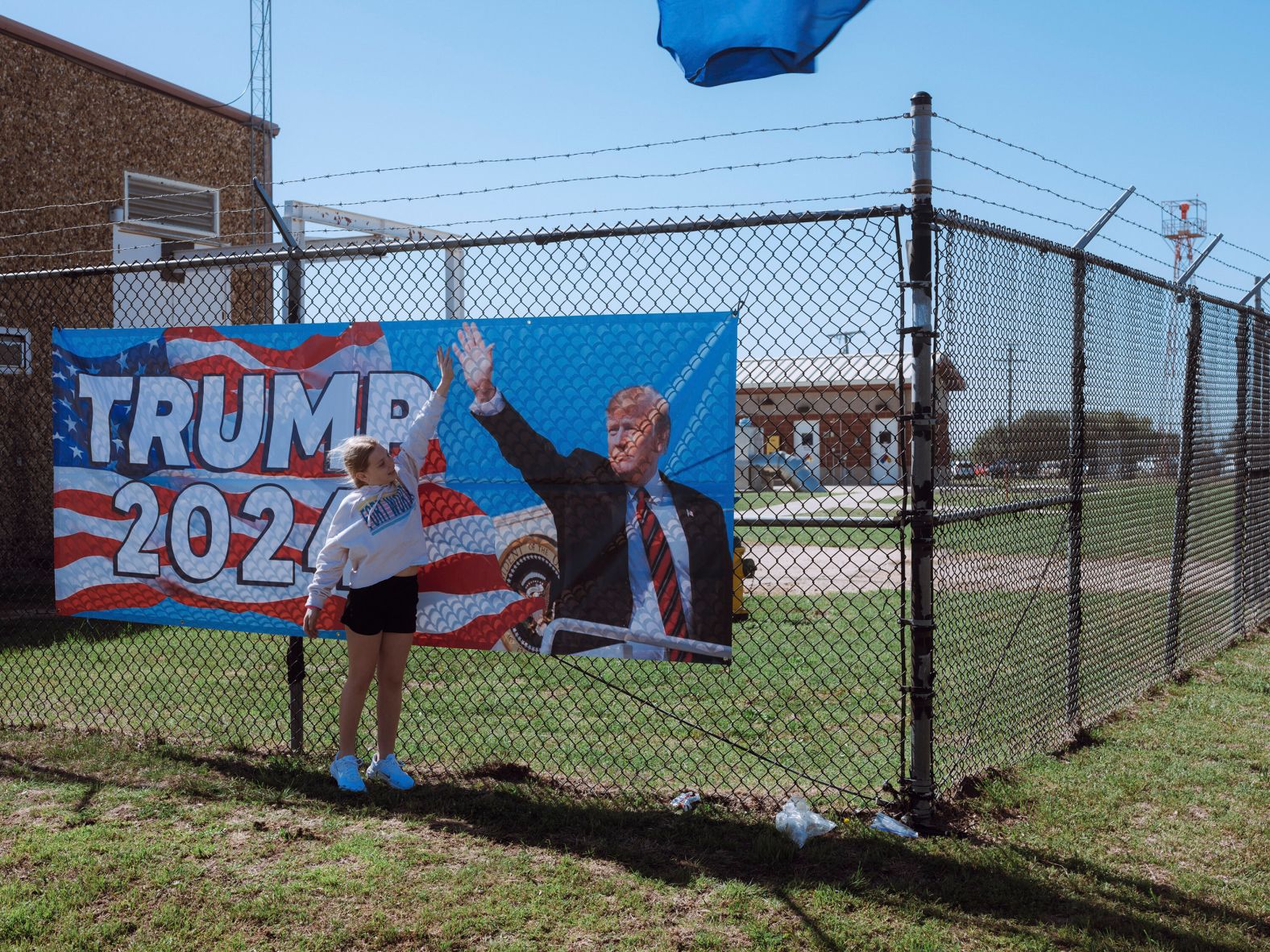 A supporter high-fives a poster at the site of Trump's rally in Waco on March 25.
