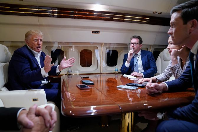 Trump speaks with reporters on his plane after he held a campaign rally in Waco, Texas, on March 25, 2023.