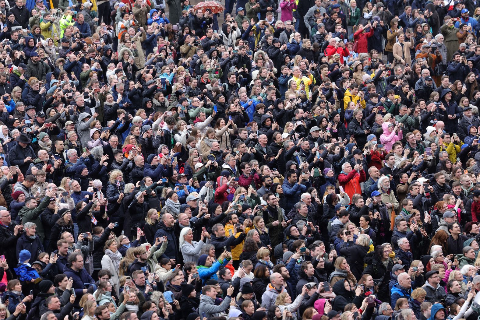 Crowds gather outside Hamburg's City Hall ahead of the King's visit.