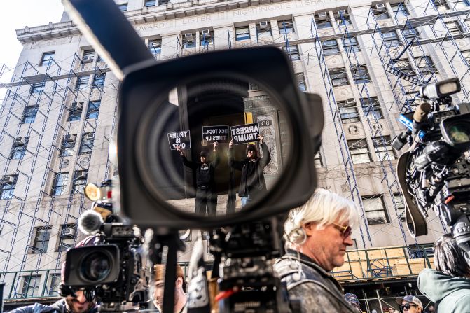 Media and protesters are seen outside Bragg's office in New York on March 20, 2023. A couple of days earlier, Trump said in a social media post <a href=