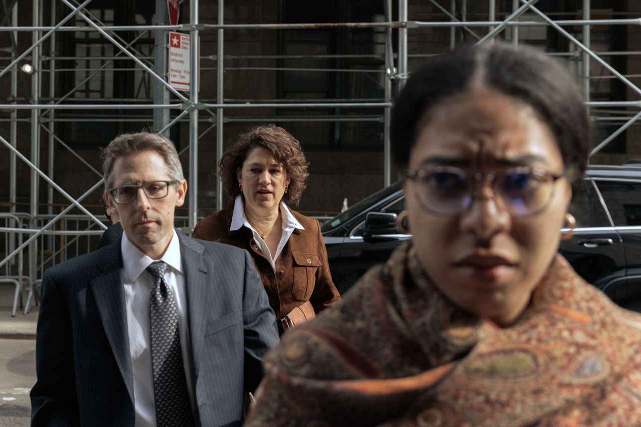 Prosecutors Matt Colangelo, left, and Susan Hoffinger, center, walk outside the Manhattan Criminal Courthouse on March 22.