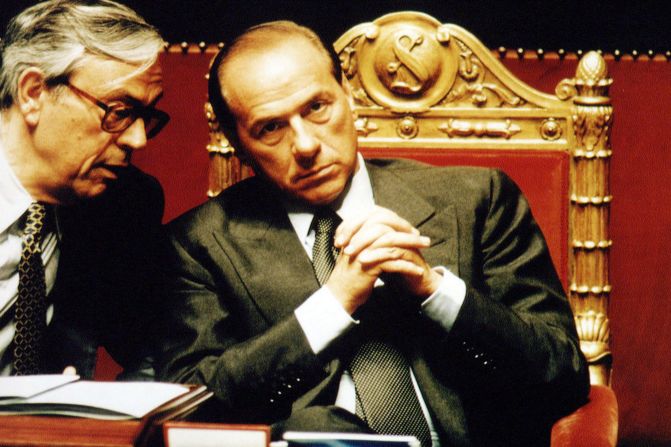 Berlusconi chats with lawmaker Cesare Previti at the Italian Senate during a vote of confidence for Berlusconi's government in May 1994.