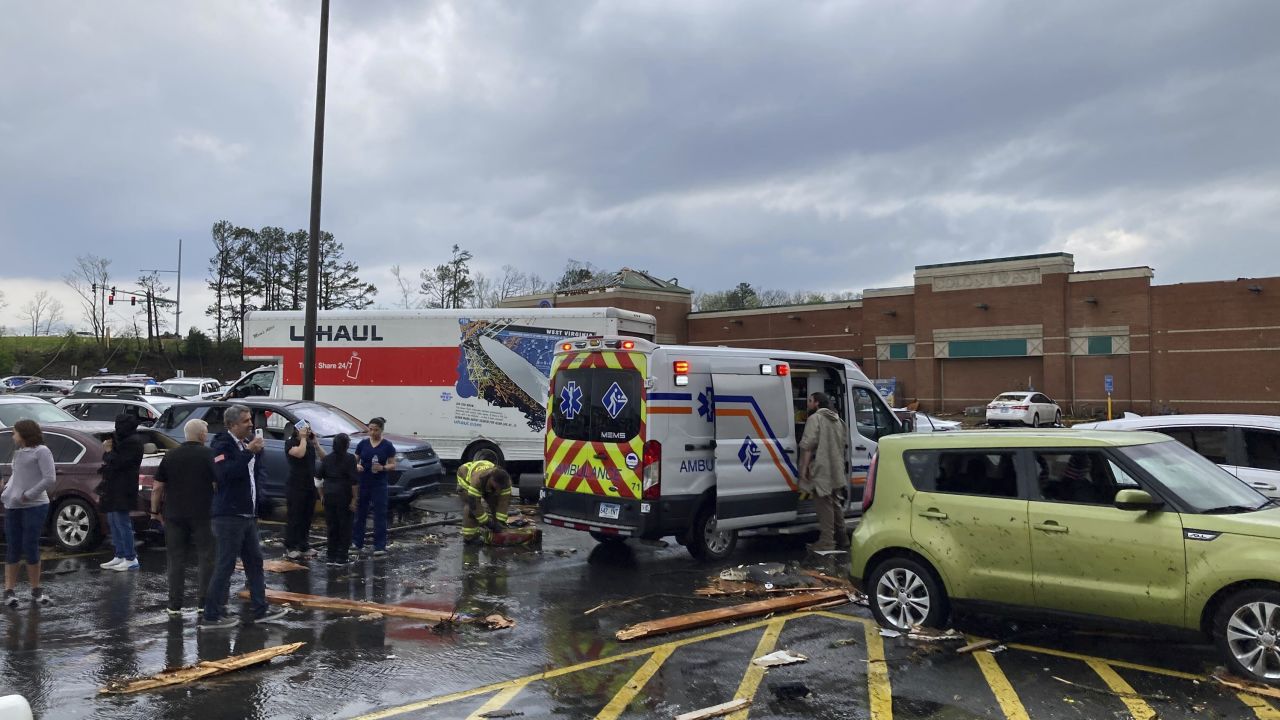 Emergency personnel check people in a parking lot after the storm in Little Rock, Arkansas.