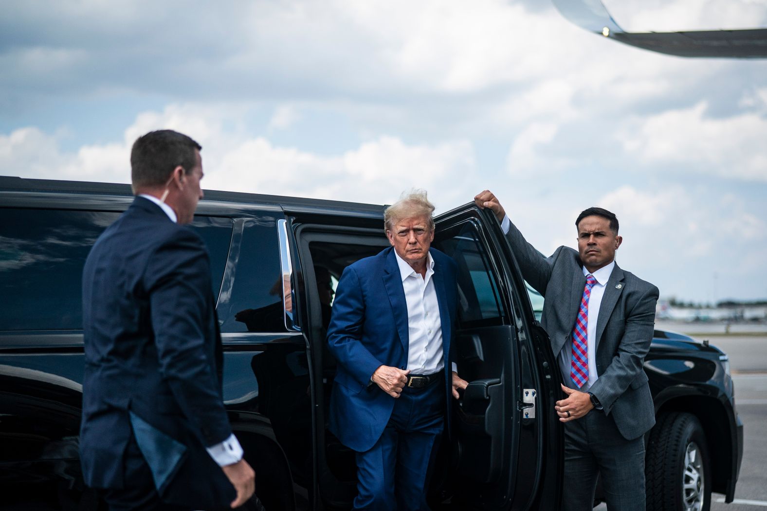Trump boards his airplane before flying to Iowa to campaign on March 13, 2023.