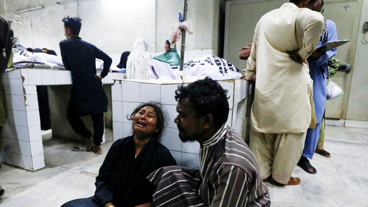 People mourn the death of a relative, who was killed along with others in a crush during a food distribution, at a hospital morgue in Karachi, Pakistan, on March 31.