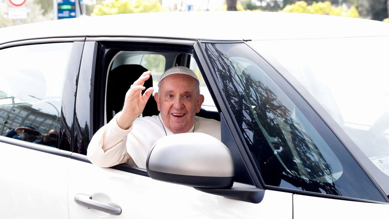 Pope Francis waves from a car as he leaves Rome's Gemelli hospital in Rome, Italy, on April 1, 2023. 