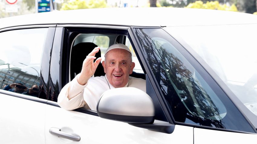 Pope Francis waves from a car as he leaves Rome's Gemelli hospital in Rome, Italy, April 1, 2023. REUTERS/Remo Casilli