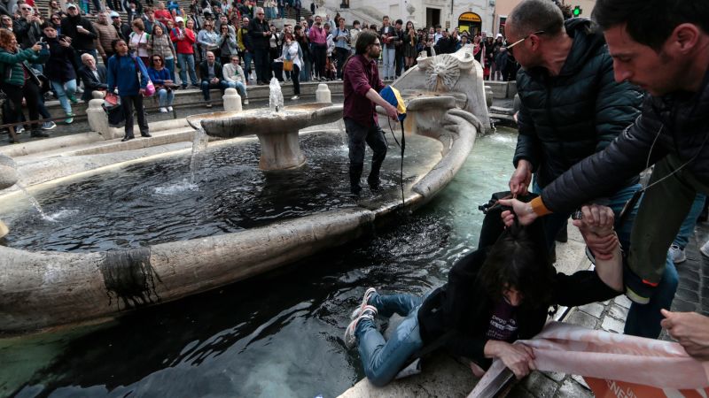 Climate activists dye Spanish Steps fountain water black | CNN