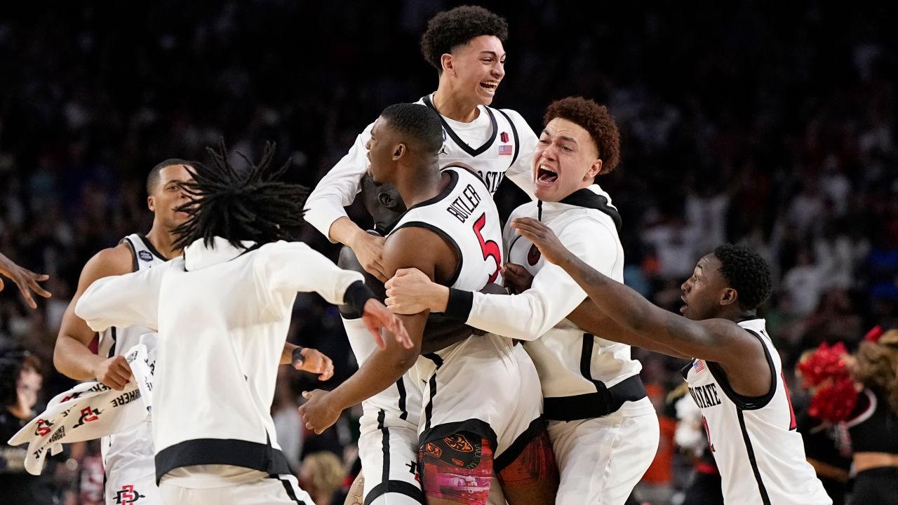 San Diego State guard Lamont Butler (5) celebrates with teammates after scoring the winning basket in the Final Four.