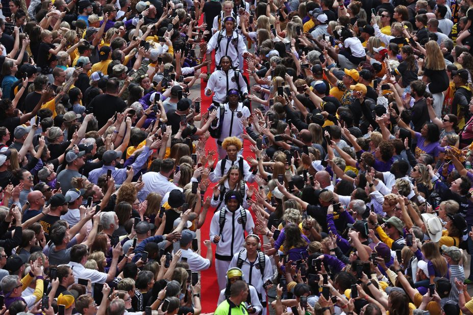 LSU players high-five fans on their way to the game.