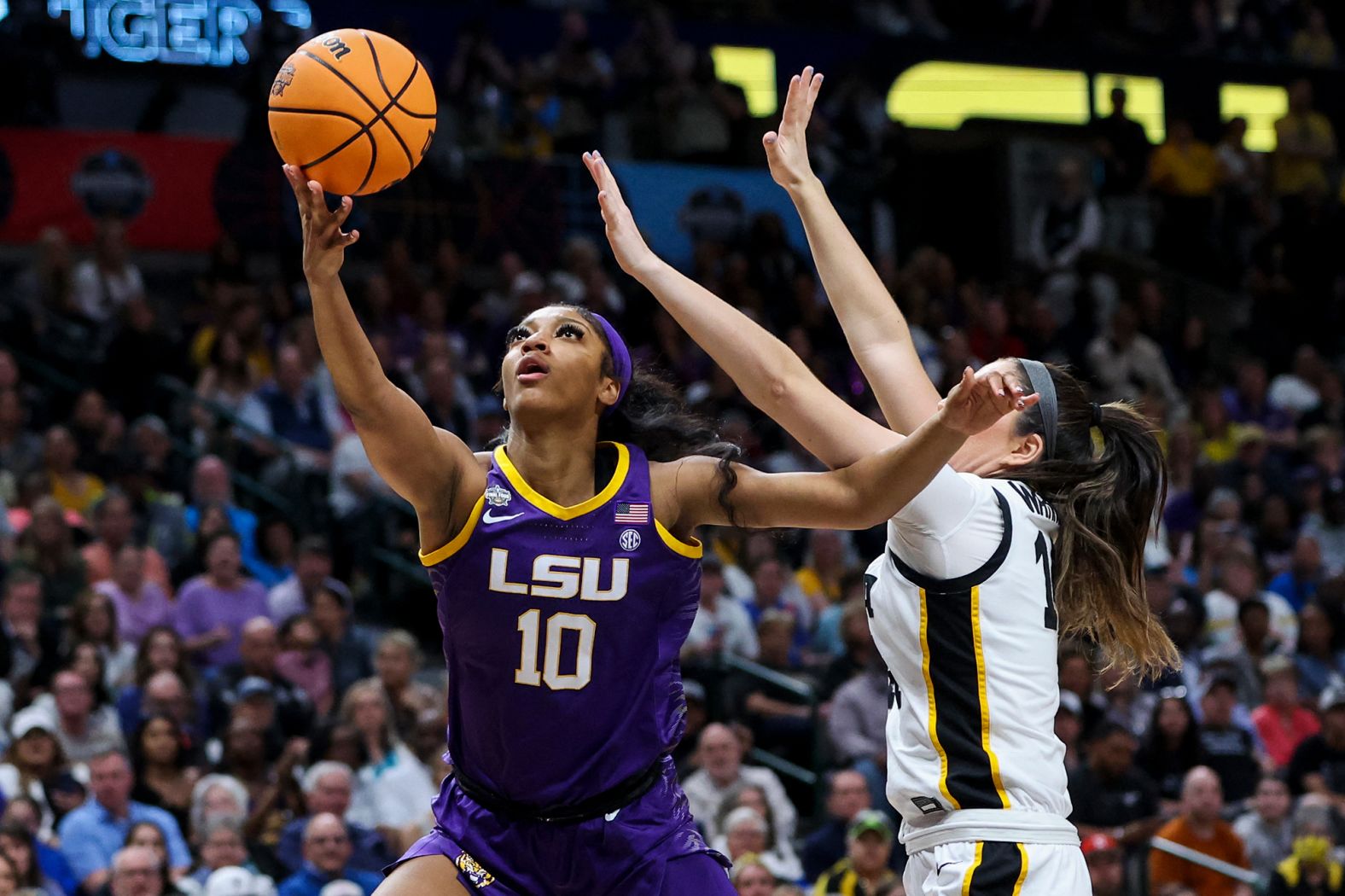 Reese is defended by Iowa's McKenna Warnock in the first quarter.