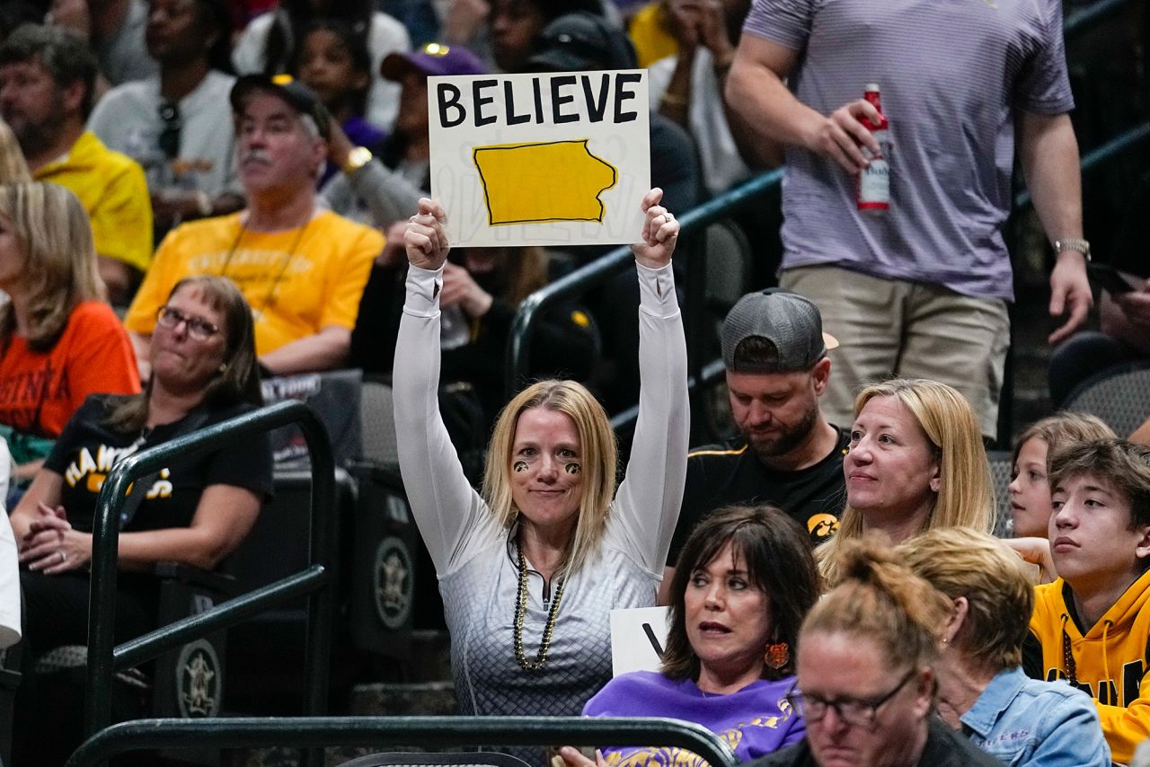 An Iowa fan holds a "believe" sign during the second half.