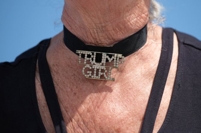 A woman wears a choker necklace that reads "Trump Girl" outside Trump's Mar-a-Lago resort on April 2, 2023.