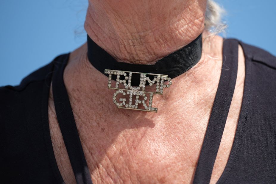 A woman wears a choker necklace that reads "Trump Girl" outside Trump's Mar-a-Lago resort on April 2.