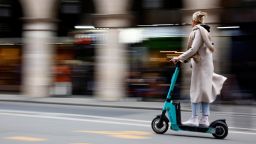A woman rides an electric scooter by Tier sharing service, on the eve of a public vote on whether or not to ban rental electric scooters in Paris, France, April 1, 2023. REUTERS/Sarah Meyssonnier
