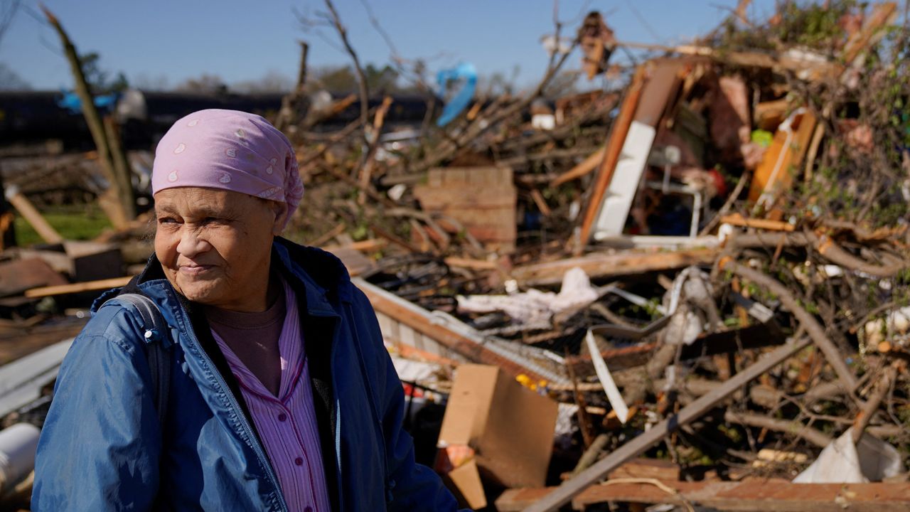 Clema Smith, who was trapped and rescued from the rubble, stands in front of the wreckage of her home in the aftermath of a tornado that struck Wynne, Arkansas, Friday.
