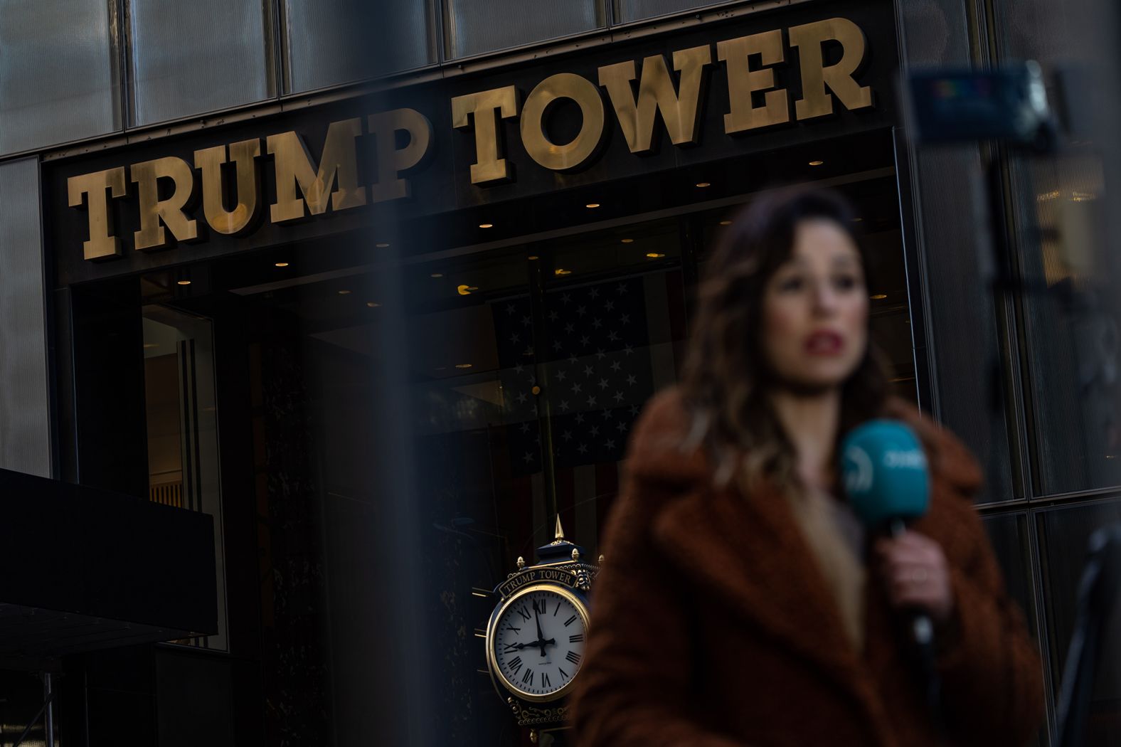 A television news reporter is seen outside Trump Tower on April 3.