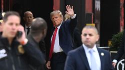 Former US President Donald Trump waves as he arrives at Trump Tower in New York on April 3, 2023. - Trump arrived on April 3, 2023 in New York where he will surrender to unprecedented criminal charges, taking America into uncharted and potentially volatile territory as he seeks to regain the presidency. The 76-yea