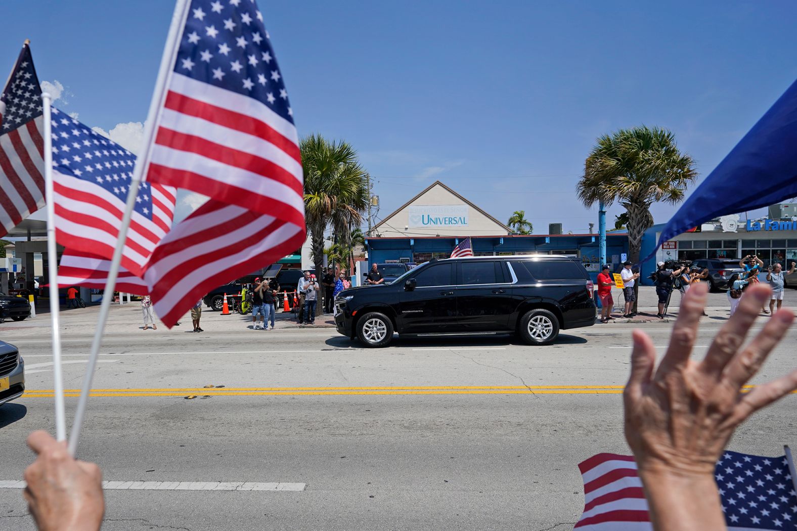 Trump supporters cheer as his motorcade passes by in West Palm Beach, Florida, on April 3.