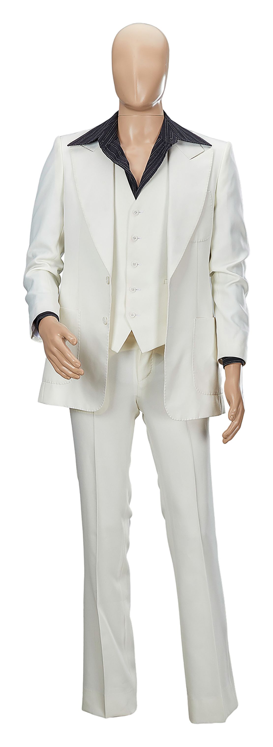 The suit features exaggerated peak lapels. 