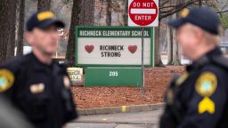 Police look on as students return to Richneck Elementary in Newport News, Virginia, on Monday, January 30, weeks after a 6-year-old student shot a teacher.