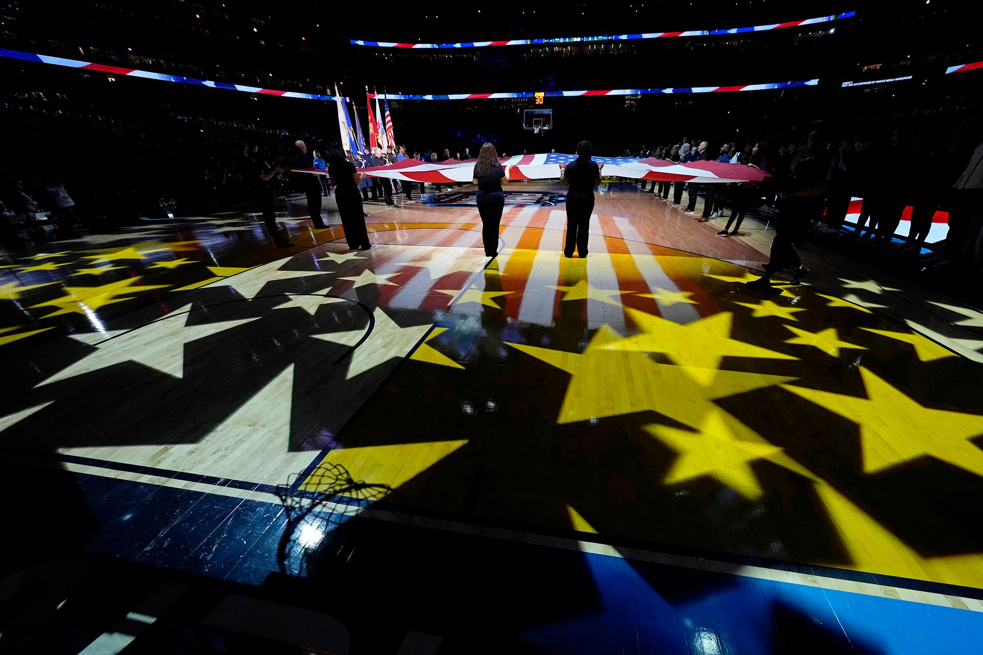 The flag is unfurled for the National Anthem before the game.