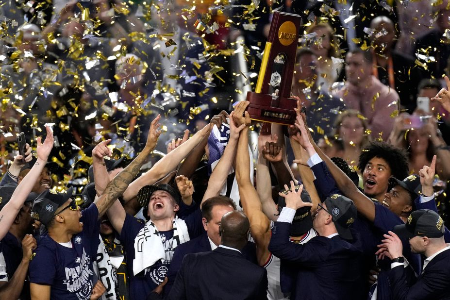 UConn players lift the championship trophy.