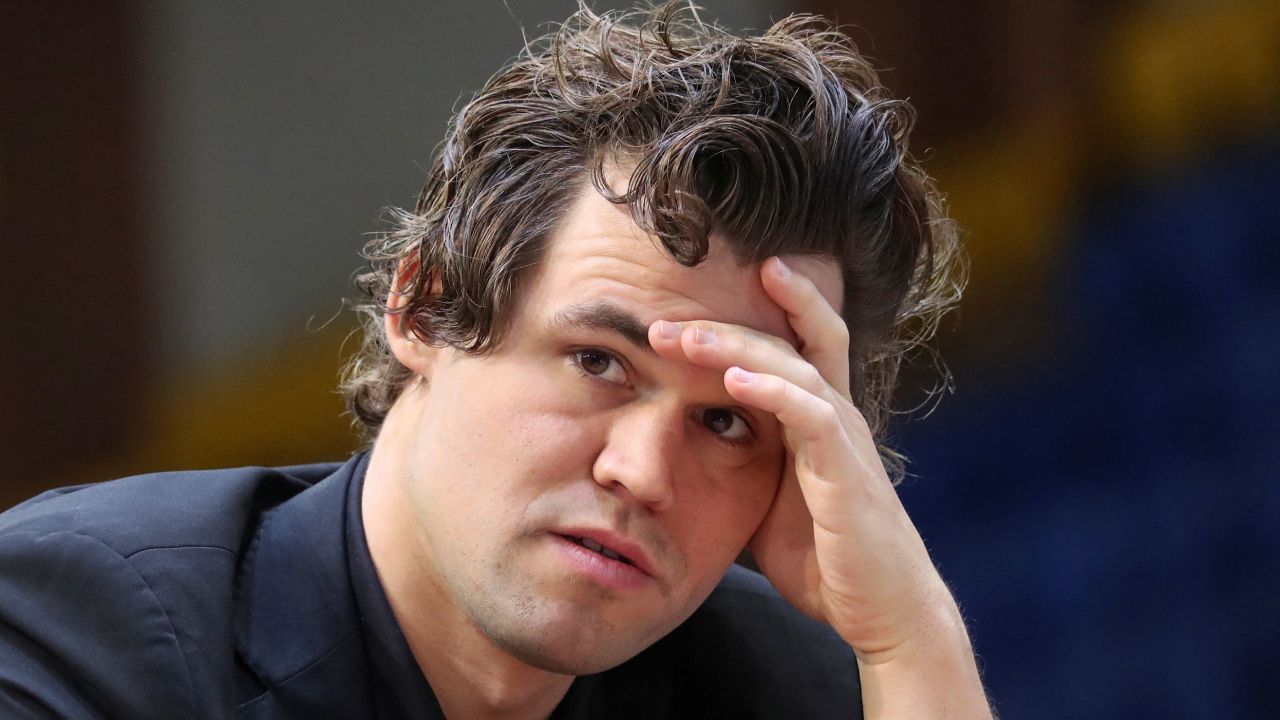 Magnus Carlsen sits in front of a chess board during a game at the World Rapid and Blitz Championships 2022 in Almaty, Kazakhstan. 