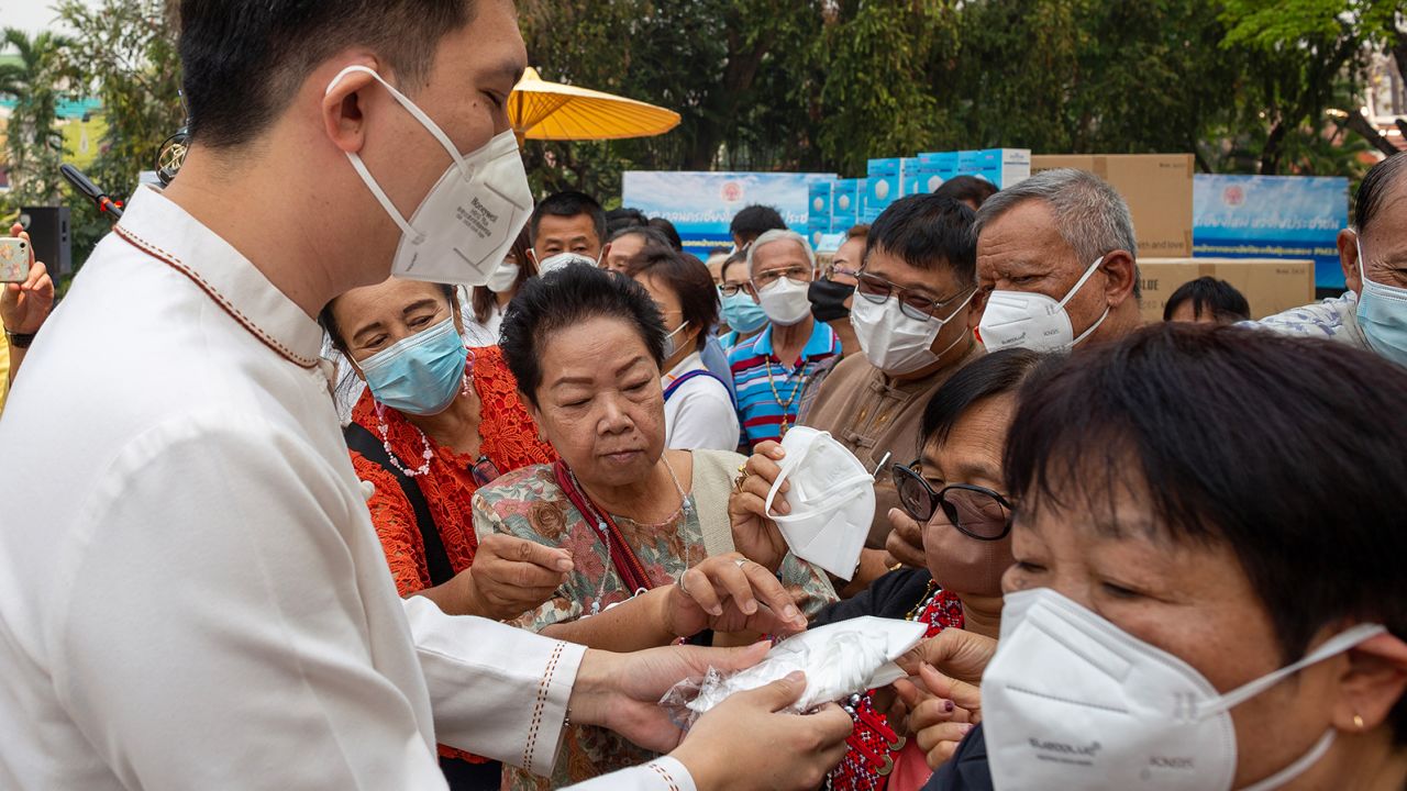 Chiang Mai's mayor Asanee Buranupakor distributes KN95 masks to residents on 30 March, 2023.