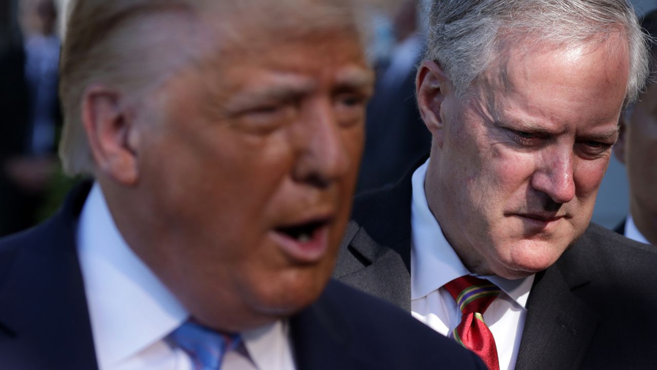 Then-President Donald Trump speaks as White House chief of staff Mark Meadows listens prior to Trump's Marine One departure from the South Lawn of the White House on July 29, 2020 in Washington.