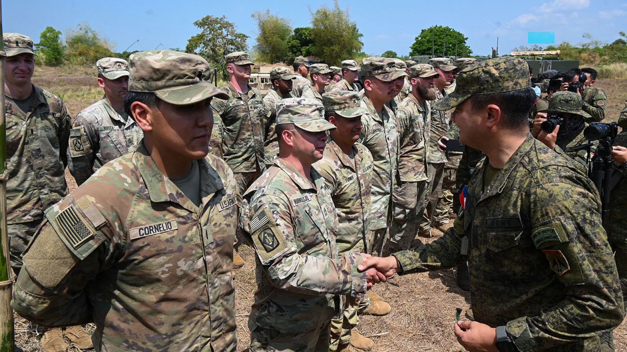 Philippine Gen. Francis Coronel, right, shakes hands with US Army soldiers after a live-fire exercise during a March 31 joint exercise between the Philippines and the US at Fort Magsaysay in the Philippines.