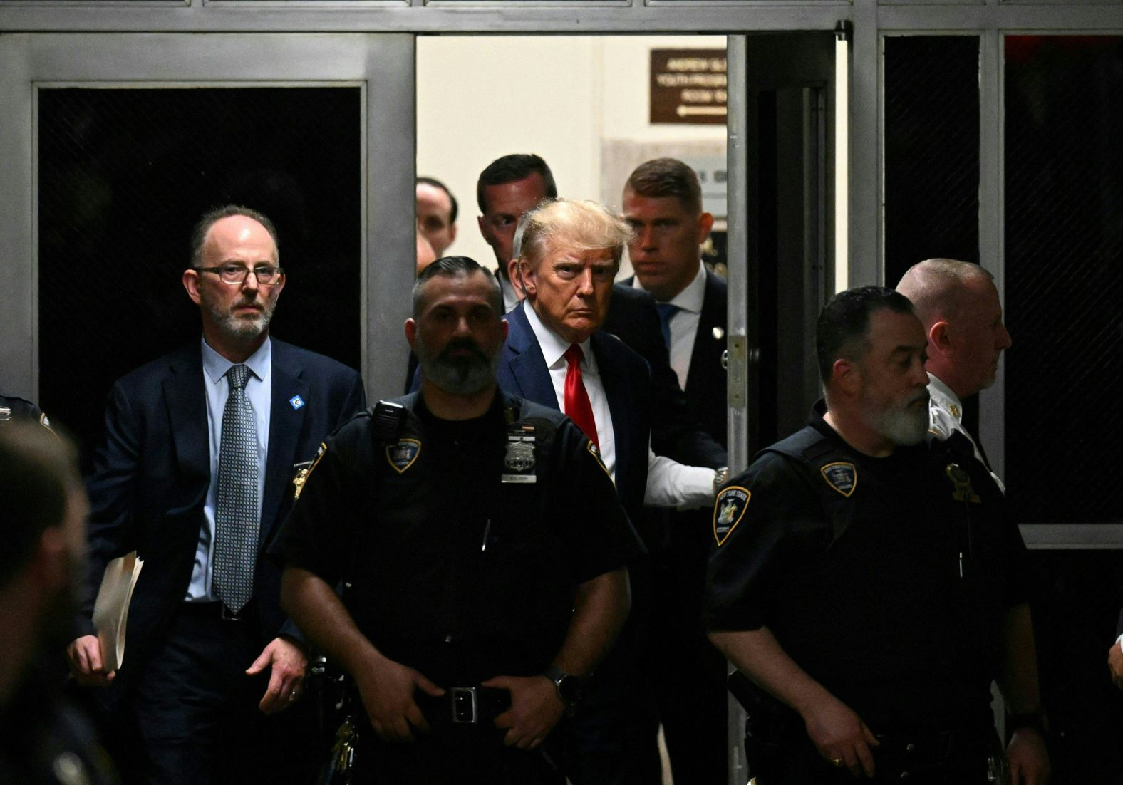 Trump walks through the courthouse on April 4.
