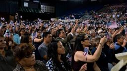 Immigrants being sworn in as United States Citizens take their oaths during the Naturalization Ceremony at El Paso County Coliseum, in El Paso, Texas on April 18, 2019. - About 740 immigrants from countries all over the world were sworn in as United States Citizens. (Photo by Paul Ratje / AFP)        (Photo credit should read PAUL RATJE/AFP via Getty Images)