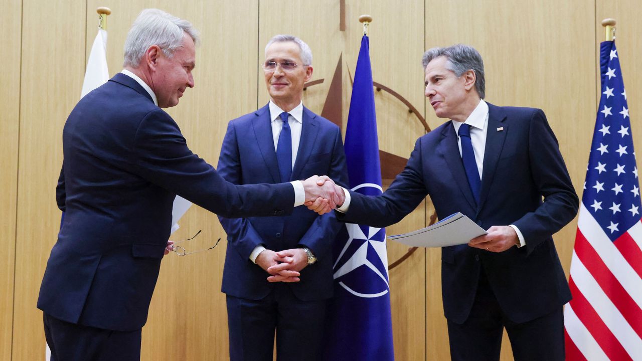 Finnish Foreign Affairs Minister Pekka Haavisto (left) shakes hands with US Secretary of State Antony Blinken (right), flanked by NATO Secretary General Jens Stoltenberg (center), in Brussels, on Tuesday.