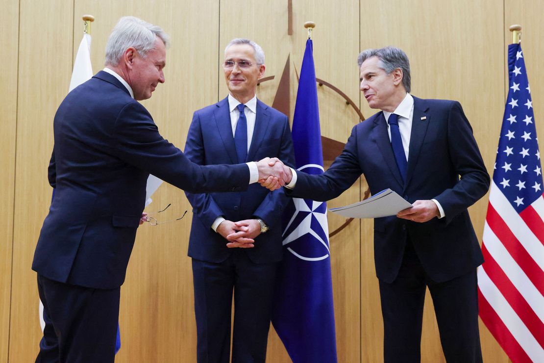 Finnish Foreign Affairs Minister Pekka Haavisto (left) shakes hands with US Secretary of State Antony Blinken (right), flanked by NATO Secretary General Jens Stoltenberg (center), in Brussels, on Tuesday.