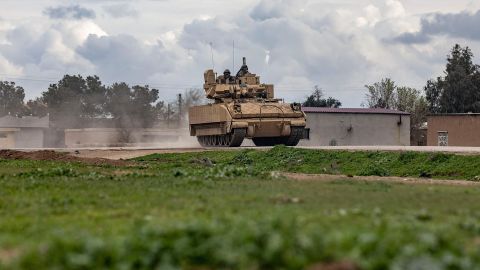 A US armoured military vehicle drives on the outskirts of Rumaylan in Syria's northeastern Hasakeh province, bordering Turkey, on March 27, 2023.