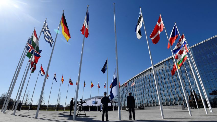 TOPSHOT - Finnish military personnel install the Finnish national flag at the NATO headquarters in Brussels, on April 4, 2023. - Finland on April 4, 2023 became the 31st member of NATO, wrapping up its historic strategic shift with the deposit of its accession documents to the alliance. (Photo by JOHN THYS / AFP) (Photo by JOHN THYS/AFP via Getty Images)