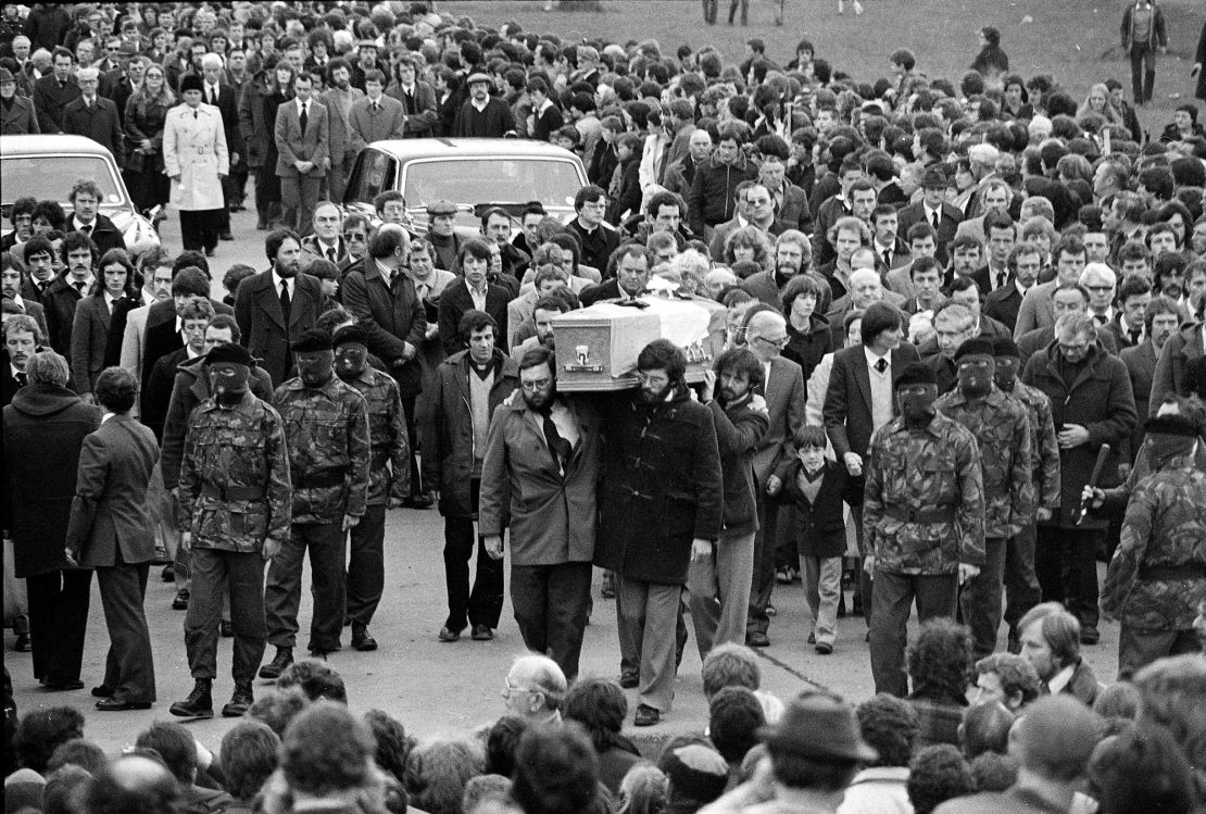 Seven-year-old Gerard Sands walks beside the coffin of his father, Catholic hunger striker Bobby Sands, as it is escorted to Belfast's Milltown Cemetery by masked IRA men on May 7, 1981.