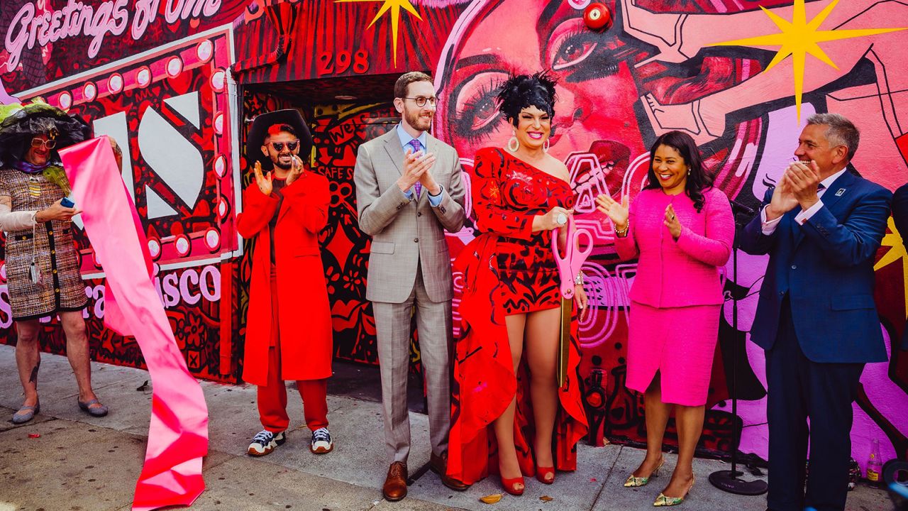 D'arcy Drollinger, along with San Francisco Mayor London Breed and others, hosting the ribbon cutting of a mural painted on the exterior of Oasis, Drollinger's cabaret and nightclub.