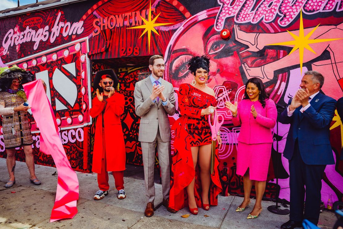 D'arcy Drollinger, along with San Francisco Mayor London Breed and others, hosting the ribbon cutting of a mural painted on the exterior of Oasis, Drollinger's cabaret and nightclub.
