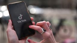 A woman displays TikTok logo on her cellphone in Denver, Colorado on Tuesday, March 28, 2023.