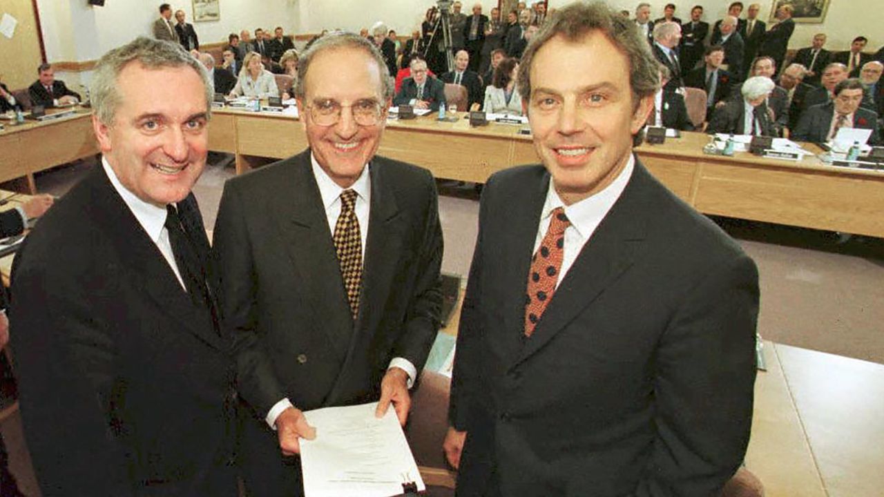 Then British Prime Minister Tony Blair, right, US Senator George Mitchell, center, and Irish Prime Minister Bertie Ahern, left, smile on April 10, 1998, after they signed a historic peace accord for Northern Ireland.