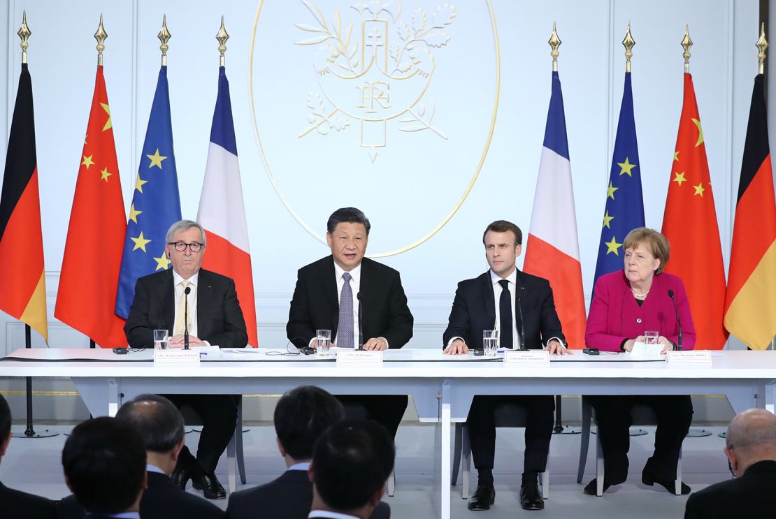 Then-European Commission President Jean-Claude Juncker, Chinese leader Xi Jinping, French President Emmanuel Macron, then-German Chancellor Angela Merkel attend an event in Paris in 2019. 