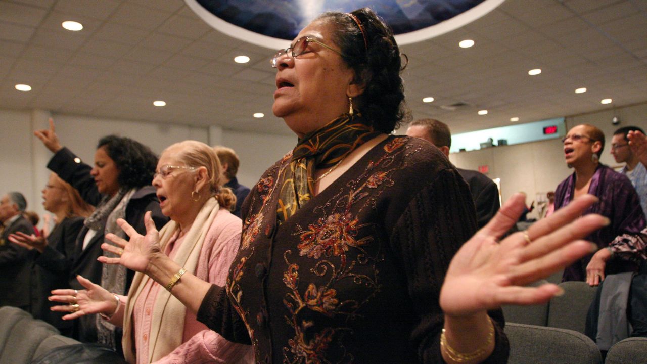 Maria Antonetty, foreground, joins others in a Spanish Easter service at the Primitive Christian Church in New York City on April 12, 2009. 