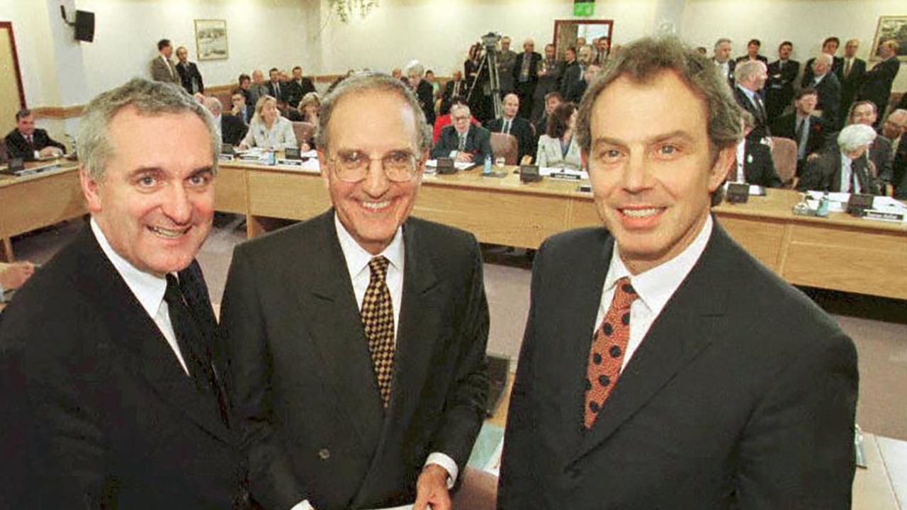 Then-Irish Prime Minister Bertie Ahern, US Senator George Mitchell and UK Prime Minister Tony Blair smile on April 10, 1998, after they signed a historic agreement for peace in Northern Ireland.