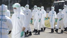 Japan's Ground Self-Defense Force (GSDF) personnel head for a chicken ranch for preventive measures against bird flu in Chitose City, Hokkaido Prefecture on March 28, 2023. An outbreak of bird flu broke out at the farm and Hokkaido began culling hens being raised at the farm on the same day.( The Yomiuri Shimbun via AP Images )