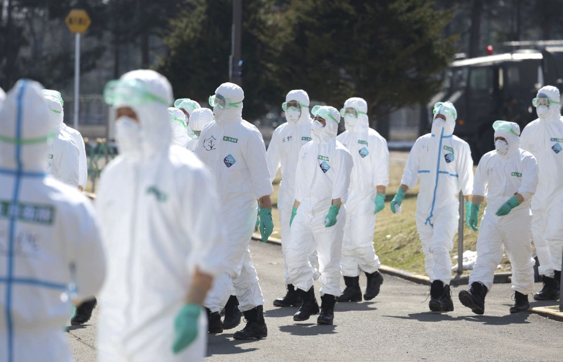 Japan's Ground Self-Defense Force personnel head to a chicken ranch to roll out preventive measures against avian flu in the city of Chitose, Hokkaido on March 28. An outbreak at the farm led to the culling of hens that day.